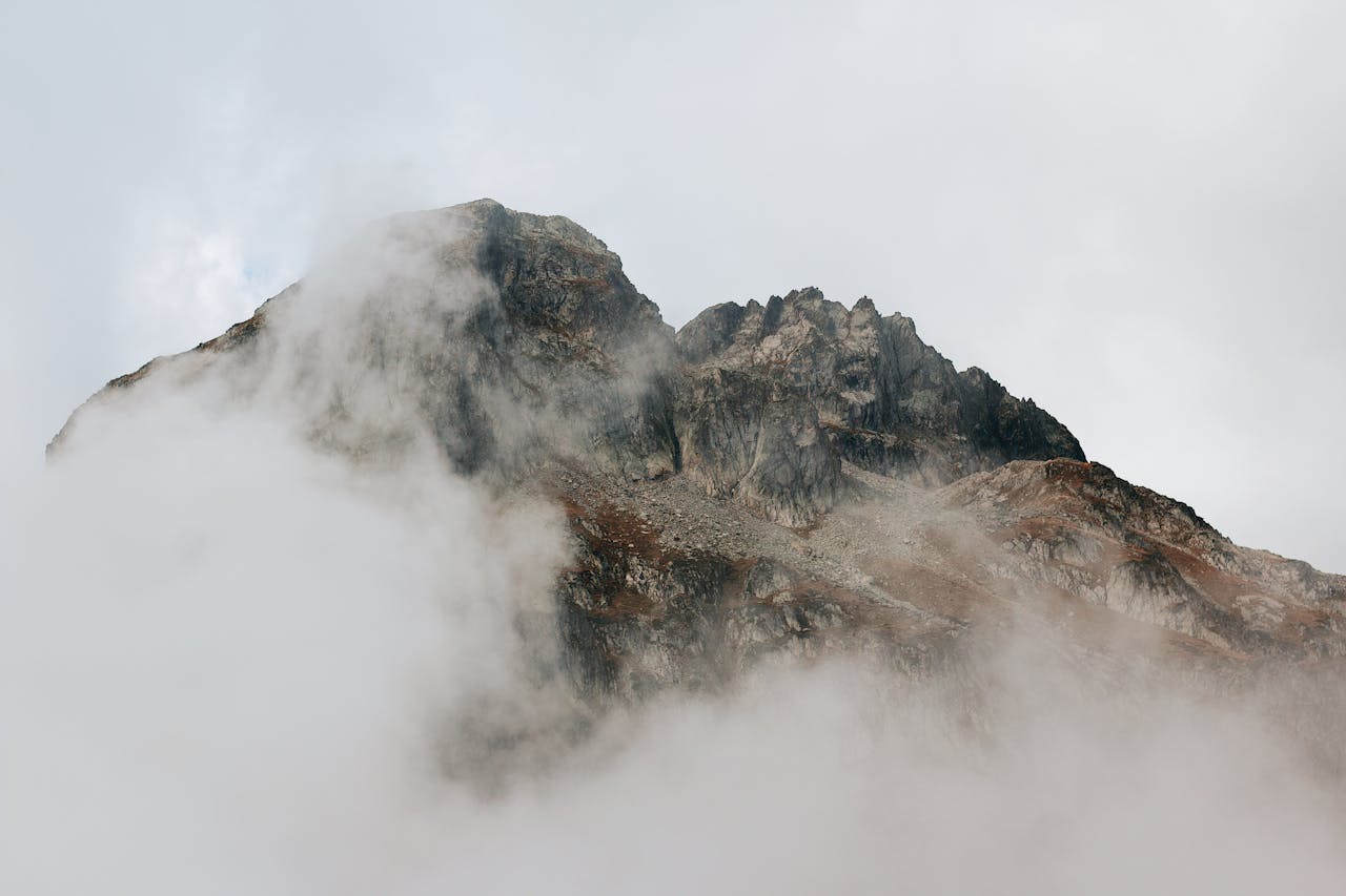 Home Dramatic mist-covered mountain peak in Cauterets, Occitanie, France.