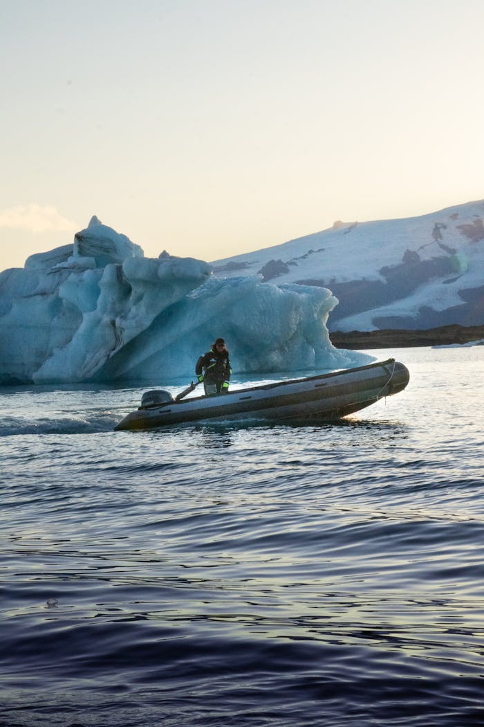 Home An adventurous boat ride near a majestic glacier in Iceland, capturing the essence of Arctic exploration.